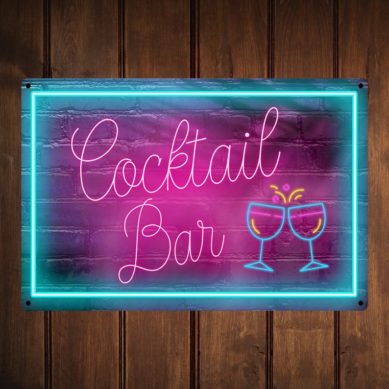 May include: Neon sign with a pink and blue gradient background. The sign says "Cocktail Bar" in white script with two pink cocktail glasses clinking together.