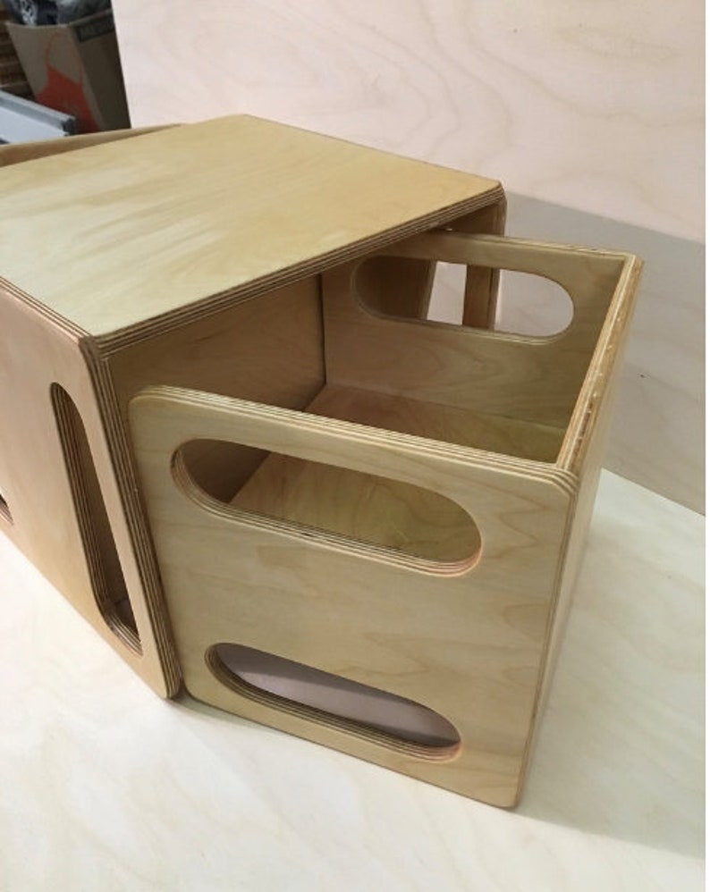 May include: A wooden box with a lid that opens to reveal a smaller box inside. The smaller box has two oval cutouts on the front.