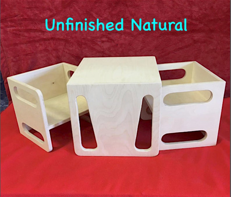 May include: Unfinished natural wood children's furniture set, including a small chair and a cube-shaped table or storage unit. The chair has a back and armrests. The table has cut-out handles. The text "Unfinished Natural" is visible.