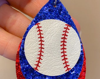 May include: Red and blue glitter teardrop shaped earrings with a white baseball in the center.