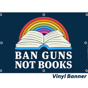 May include: A blue vinyl banner with a rainbow and an open book. The text on the banner reads "BAN GUNS NOT BOOKS".