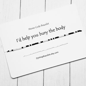 May include: A white card with black text that reads "Morse Code Bracelet I'd help you bury the body" and a black and white beaded bracelet. The card also includes the website "DIYWrapBracelets.etsy.com".
