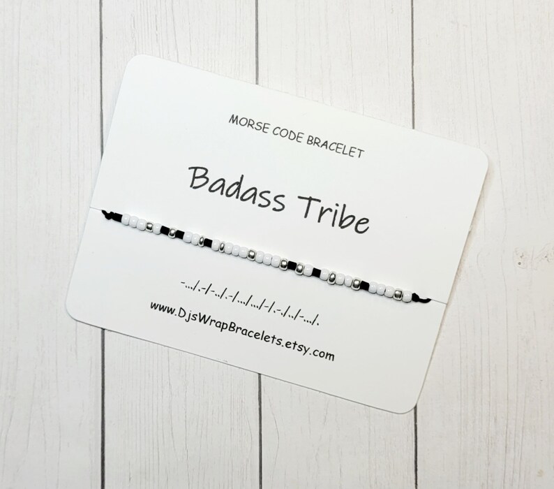 May include: A black and white beaded bracelet with the words "Badass Tribe" and the morse code translation on a white card. The card also includes the website "www.DjsWrapBracelets.etsy.com".