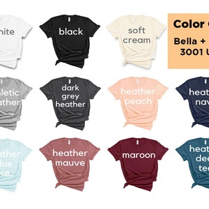 K&ouml;nnte beinhalten: Ein Farbf&uuml;hrer zeigt T-Shirts in verschiedenen Farben: Wei&szlig;, Schwarz, Soft Cream, Athletic Heather, Dark Grey Heather, Heather Peach, Heather Navy, Heather Blue Ice, Heather Mauve, Maroon und Heather Deep Teal. Der Text "Color Guide" und "Bella + Canvas 3001 Unisex" sind ebenfalls sichtbar.