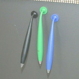 May include: Three colourful pens with rounded tips and a suction cup on the top. The pens are black, green, and blue.