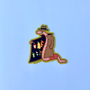 Könnte beinhalten: Ein Cartoon-Wurm, der einen braunen Mantel und einen Hut trägt, hält ein Schild mit einer Auswahl an Obst und Gemüse. Auf dem Schild steht "@kiddlyonsart".