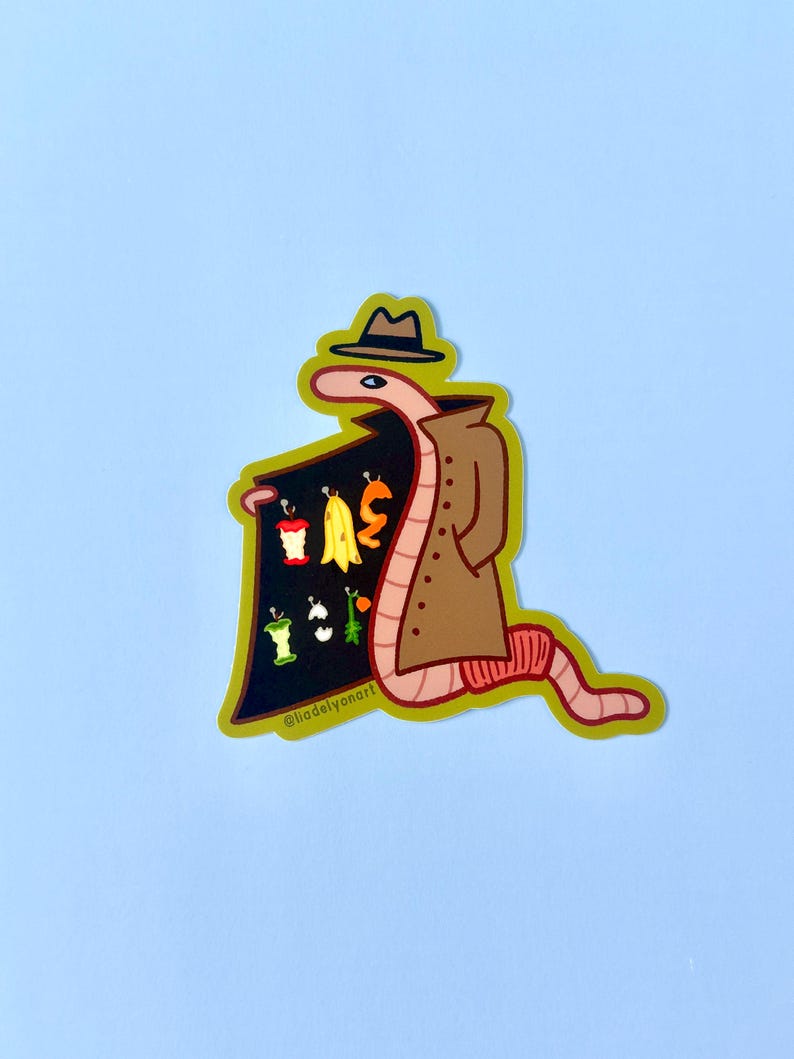 May include: A cartoon worm wearing a brown trench coat and a fedora hat, holding a sign with a variety of fruits and vegetables. The sign says "@liadelvanart".