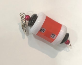 Red beaded row counter with red and black glass beads