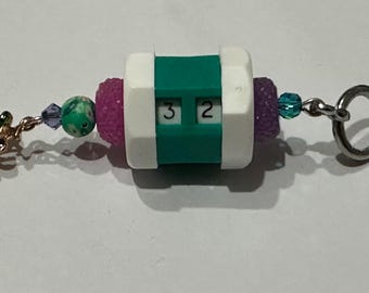 Teal beaded row counter with blackberry charm