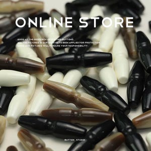 May include: A close-up of a variety of brown, black, and white horn buttons. The buttons are shaped like small, elongated barrels with a slight curve in the middle. The text "ONLINE STORE" and "BUTTON STUDIO" are visible in the image.