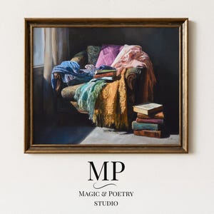 May include: A framed painting depicts a cozy interior scene. A patterned armchair is draped with colorful blankets and pillows. A stack of books sits nearby. The painting has a gold frame and the text "MP MAGIC & POETRY STUDIO" at the bottom.
