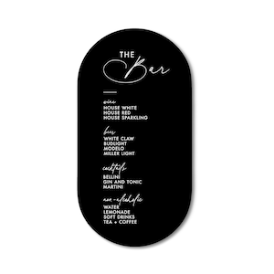 May include: Black oval sign with white text that reads "THE Bar" and lists drink options: wine, beer, cocktails, and non-alcoholic beverages.