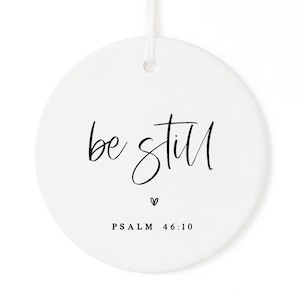 May include: White ceramic ornament with black calligraphy that reads "be still" and the text "PSALM 46:10".