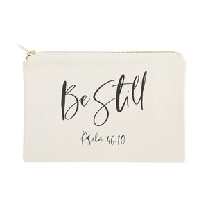 May include: A beige canvas zippered pouch with the text "Be Still" in black cursive lettering and "Psalm 46:10" in smaller black lettering below.