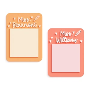 May include: Two orange and pink sticky note holders with blank sticky notes. The top holder has the text "Miss Beaumont" and a pencil icon. The bottom holder has the text "Miss Williams" and a pencil icon.