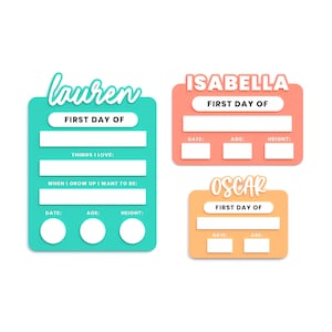 May include: Three printable first day of school signs with the names Lauren, Isabella, and Oscar. Each sign has a space for the date, age, and height. The Lauren sign is turquoise, the Isabella sign is peach, and the Oscar sign is orange.