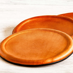 Handmade personalized leather coasters with an elegant, original design ideal for beer or whiskey glasses