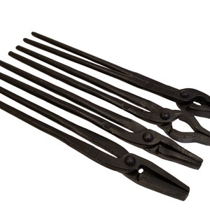 May include: Set of six black blacksmith tongs with different jaw shapes and sizes. The tongs are made of forged steel and have a traditional design.