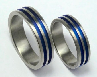 A pair of anodized titanium engagementrings. Hand crafted titanium rings. Titanium jewelry.