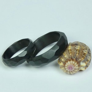 Pair of all around random facetted zirconium wedding rings, engagement rings. Zirconium jewelry. Zirconium rings.