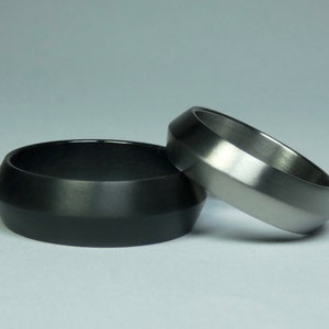 SET of black zirconium and titanium rings. Zirconium and titanium engagementrings. Zirconium and titanium jewelry. Pair of rings.