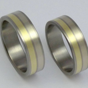 Titanium and 14 carat white and yellow gold SET of rings. Titanium, 14 carat gold weddingbands.