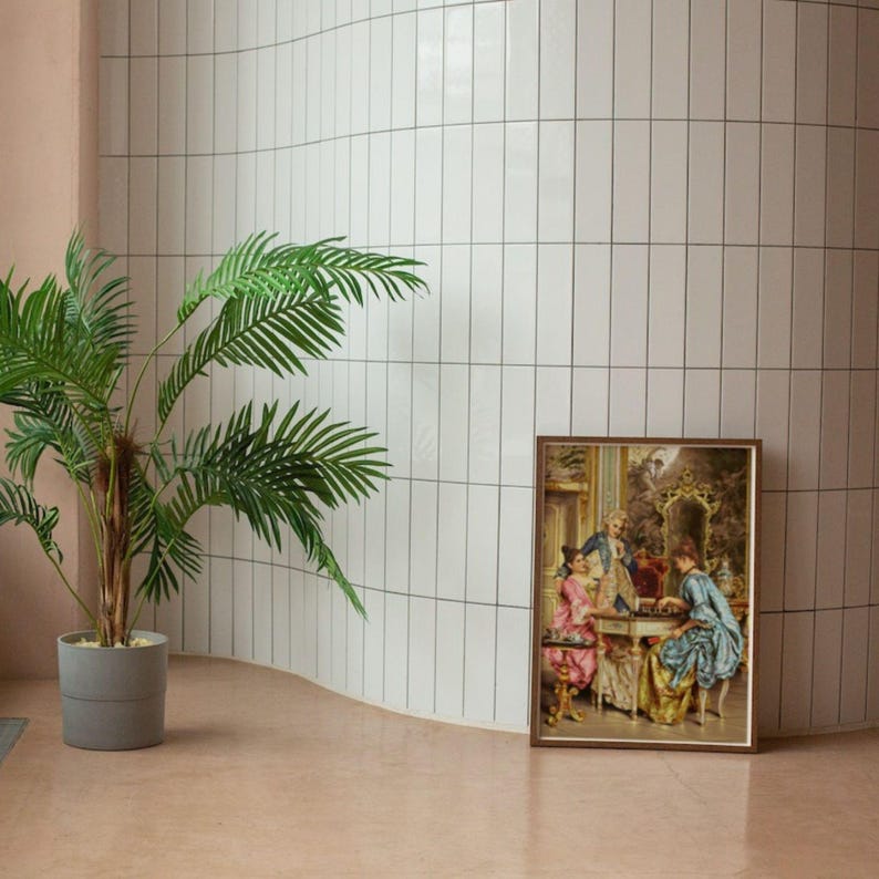 Framed Rococo chess print on the floor next to a tall palm; frame not included.