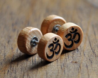 May include: Two wooden earrings with a silver post and a black Om symbol engraved on each earring.