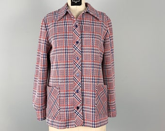 May include: A red, white, and blue plaid button-up shirt with long sleeves and two front pockets.