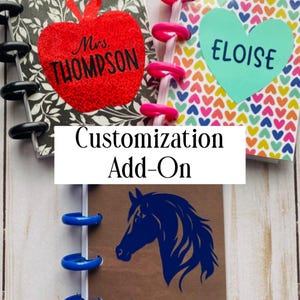 May include: Three disc-bound notebooks featuring personalized covers. One has a black and white floral pattern with a red glitter apple labeled Mrs. Thompson. Another has a colorful heart pattern with a teal heart labeled Eloise. One has a horse graphic.