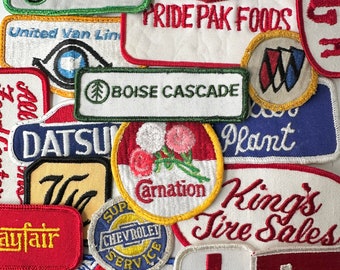 May include: A collection of vintage embroidered patches featuring various designs and text, including "Pride Pak Foods", "Boise Cascade", "King's Tire Sales", and "Datsu".