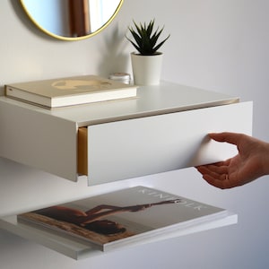 White floating nightstand with drawer and an extra shelf