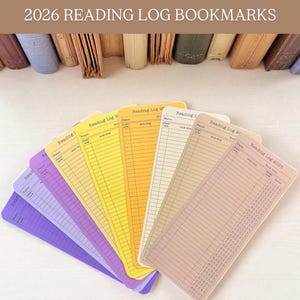 May include: A fan of colorful reading log bookmarks in shades of purple, yellow, and beige. Each bookmark features a lined layout for recording book details. The text "2026 Reading Log Bookmarks" is at the top.