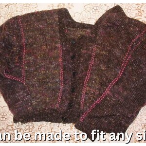 May include: A dark brown, button-down cardigan sweater with pink stitching accents. The sweater has a textured knit pattern and is displayed on a white lace surface. The text "Can be made to fit any size" is visible at the bottom.
