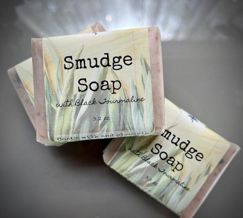May include: Three bars of handmade soap with a white label that reads "Smudge Soap with Black Tourmaline 3.2 oz. Goat's milk and glycerin".
