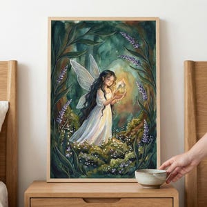 May include: Watercolor painting of a fairy in a forest setting. The fairy, with long dark hair and white dress, holds a glowing crystal. The artwork features a wooden frame, with green foliage and purple flowers surrounding the fairy.