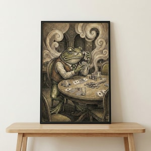 May include: A framed print depicts a frog in a waistcoat and glasses playing poker at a round table. The frog is holding cards and appears to be contemplating his next move. The scene is detailed with poker chips, glasses, and smoke.
