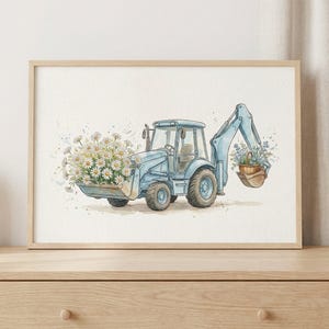 May include: Watercolor illustration of a light blue backhoe loader filled with daisies in the front bucket and a basket of blue flowers in the back. The artwork is framed in a light wood frame and set against a neutral background.