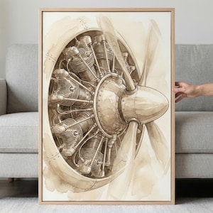 May include: Watercolor painting of an airplane engine and propeller in sepia tones. The artwork features detailed mechanical components and a blurred propeller, framed in a light wood. The art piece is displayed on a wall.