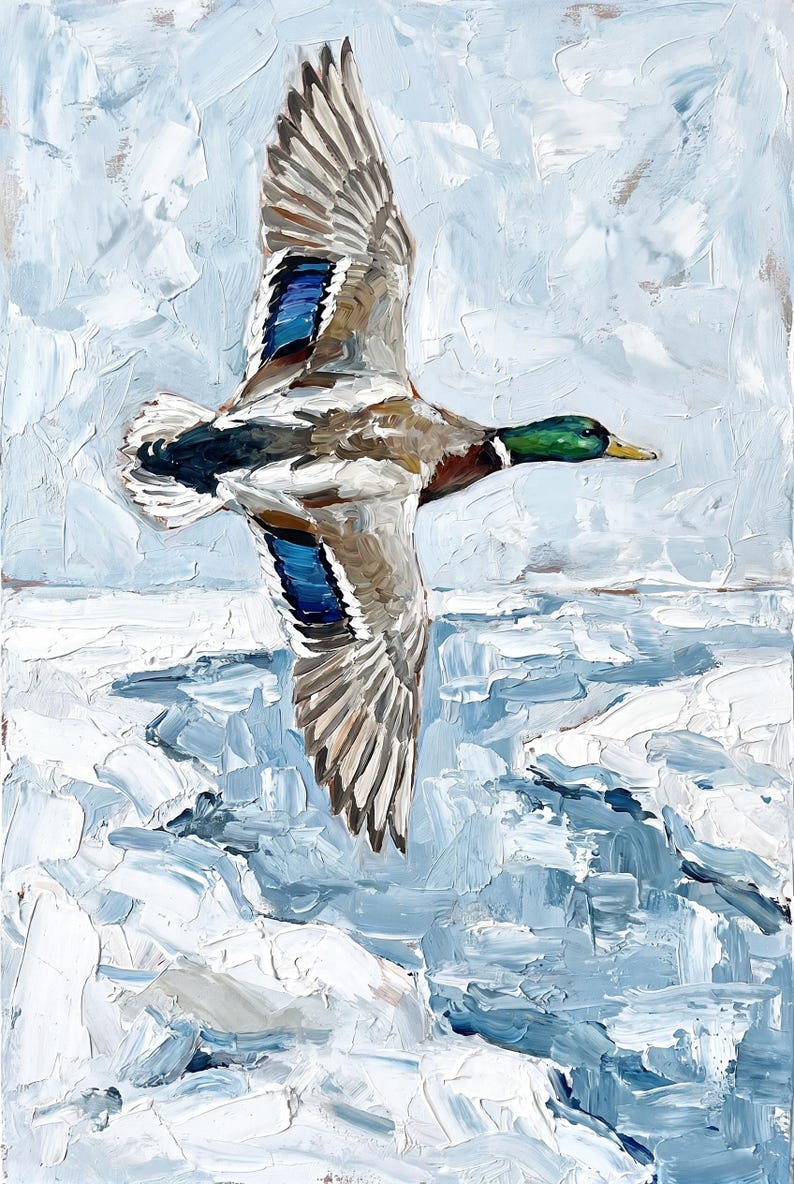 Textured winter mallard duck wall art flying over a snowy, icy lake with thick blue and white strokes.