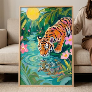 May include: A framed art print featuring a vibrant painting of a tiger drinking from a jungle stream. The artwork showcases the tiger's orange and black stripes, with a reflection in the water. Lush green foliage, pink flowers, and a bright yellow sun complete the scene.