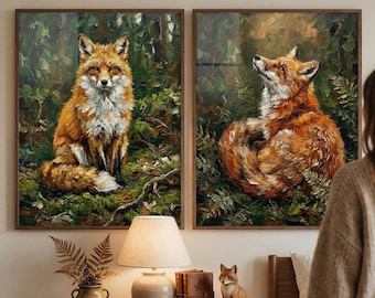 May include: Two framed paintings depict foxes in a forest setting. One shows a fox sitting, the other looking up. The artwork features rich colors of orange, brown, and green, with a textured, painterly style. The frames are dark wood.