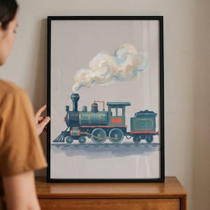 May include: A framed art print featuring a watercolor illustration of a vintage steam train. The train is painted in shades of blue, green, and red, with a plume of white and yellow smoke. The artwork is displayed in a black frame.