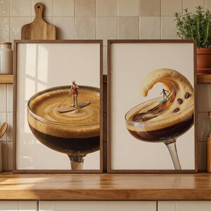 May include: Two framed art prints featuring coffee-themed surreal scenes. One shows a person paddleboarding in a coffee cup, the other depicts a surfer riding a coffee wave. Both prints are in brown wooden frames.