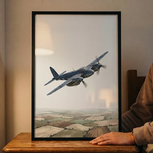 May include: A framed print featuring a vintage blue airplane soaring above a patchwork landscape. The aircraft has two propellers and is set against a muted sky. The artwork is displayed in a black frame, adding a classic touch to the aviation-themed art.