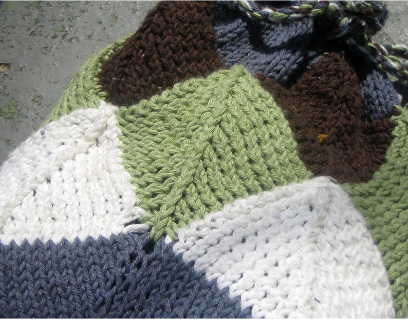 A close-up shot of a drawstring bag made partially from mitered squares. The close up shows one mitered square in the centre of the image.