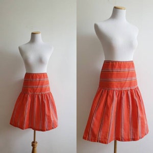 Vintage 70s, 1970s bright orange high waisted a line skirt with rainbow colored stripes, printed stiff cotton skirt size small S