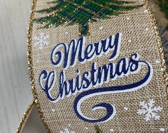 May include: Close-up of a festive ribbon with a burlap texture. The ribbon features a green Christmas tree design, white snowflakes, and the words "Merry Christmas" in navy blue script. The edges are trimmed with gold glitter.