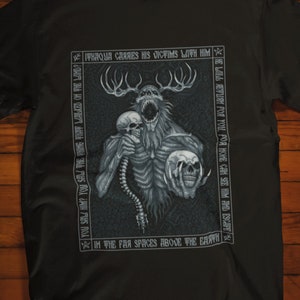 May include: Black t-shirt with a graphic print of a creature with antlers and skulls. The text around the creature reads "OUR CARRIES HIS VICTIMS WITH HIM", "RETURN FOR YOU", "YOUR POR NOVE GAM SEM NEGAT", and "IN THE FAR SPICES ABOVE THE EARTH".