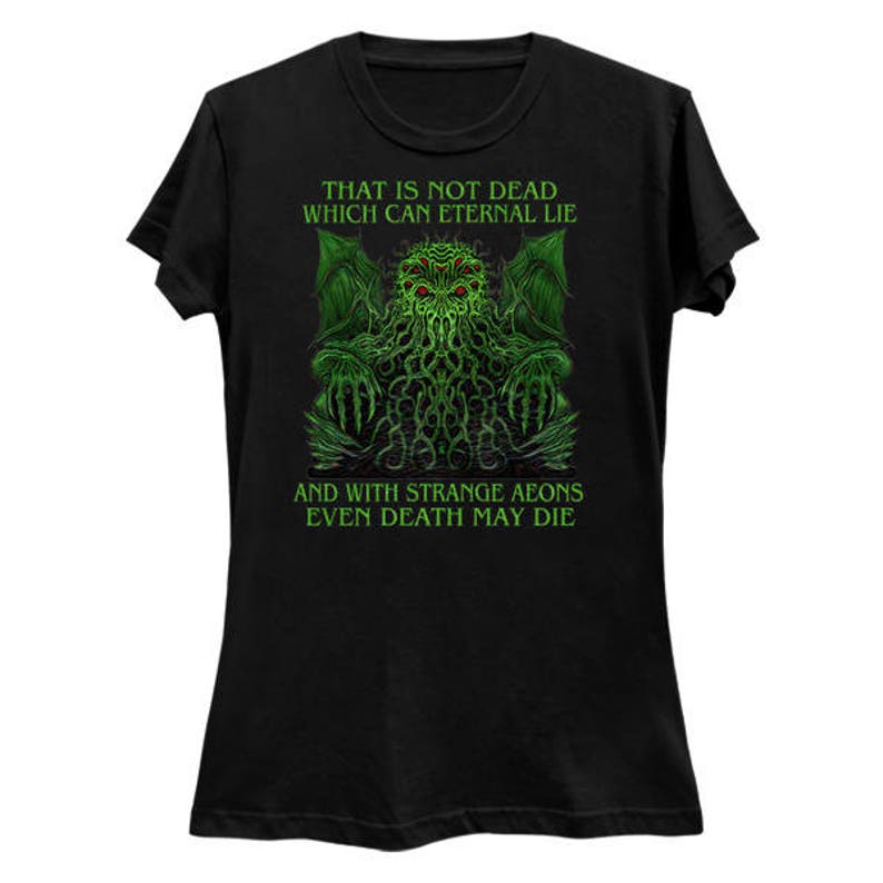 May include: Black t-shirt featuring a green and red graphic of a creature with text that reads "THAT IS NOT DEAD WHICH CAN ETERNAL LIE" and "AND WITH STRANGE AEONS EVEN DEATH MAY DIE".